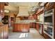 Traditional kitchen with wood cabinets, an island, stainless steel double ovens, and tile flooring at 5110 Jett Forest Trl, Atlanta, GA 30327