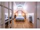 Attic bedroom featuring hardwood floors, natural light, and a writing desk at 606 Glenwood Pl, Atlanta, GA 30316