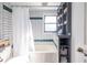 Bathroom features subway tiles, bathtub and convenient built-in shelves at 606 Glenwood Pl, Atlanta, GA 30316