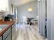 This dining area includes a view of the modern kitchen, a round dining table, and a laundry area separated by a curtain at 86 Kelly Ct, Dallas, GA 30157