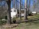 This charming home is surrounded by mature trees and features a welcoming front porch and stairs at 86 Kelly Ct, Dallas, GA 30157