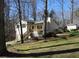 This charming home is surrounded by mature trees and features a welcoming front porch, stairs, and a storage shed at 86 Kelly Ct, Dallas, GA 30157