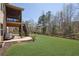 Expansive backyard featuring well manicured lawn, fenced perimeter, and screened in porch at 194 Lakestone Parkway, Woodstock, GA 30188
