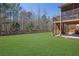 Expansive backyard featuring well manicured lawn, fenced perimeter, and screened in porch at 194 Lakestone Parkway, Woodstock, GA 30188