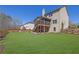 Expansive backyard featuring well manicured lawn, fenced perimeter, and screened in porch at 194 Lakestone Parkway, Woodstock, GA 30188