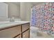 Powder room featuring a granite countertop, white sink, and a colorful shower curtain at 194 Lakestone Parkway, Woodstock, GA 30188