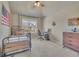 Bedroom featuring a window view, ceiling fan, and neutral colored carpet at 194 Lakestone Parkway, Woodstock, GA 30188