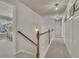 Upstairs hallway featuring wood railing, carpet, and access to bedrooms at 194 Lakestone Parkway, Woodstock, GA 30188