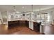 Open-concept kitchen with an oversized island and granite countertops at 194 Lakestone Parkway, Woodstock, GA 30188