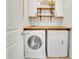 A bright laundry room featuring front load washer/dryer and butcher block folding counter at 194 Lakestone Parkway, Woodstock, GA 30188