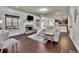 Cozy living room with brick fireplace, large windows, and hardwood floors, creating a warm and inviting space at 194 Lakestone Parkway, Woodstock, GA 30188