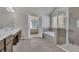 Main bathroom featuring a double vanity with marble countertops, a glass shower, and a soaking tub at 194 Lakestone Parkway, Woodstock, GA 30188