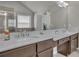Main bathroom boasts a double vanity with marble countertops, silver hardware, and great lighting at 194 Lakestone Parkway, Woodstock, GA 30188