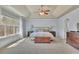 Serene main bedroom with a tray ceiling, large window, and plush carpeting, creating a peaceful retreat at 194 Lakestone Parkway, Woodstock, GA 30188