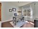 Well-lit home office with a large window, desk, and comfortable seating, ideal for remote work at 194 Lakestone Parkway, Woodstock, GA 30188