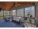 Relaxing screened porch with comfortable seating, offering a peaceful outdoor living space at 194 Lakestone Parkway, Woodstock, GA 30188