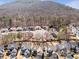 Aerial view showcasing neighborhood with mature trees and mountain in the background at 441 Highlands Loop, Woodstock, GA 30188
