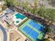 Community pool and tennis courts surrounded by lush greenery, offering recreational amenities for residents at 441 Highlands Loop, Woodstock, GA 30188