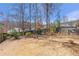 Spacious backyard with mature trees and landscaping, offering a serene and private outdoor space at 441 Highlands Loop, Woodstock, GA 30188