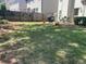 Spacious backyard with green lawn, wooden fence, and patio area at 441 Highlands Loop, Woodstock, GA 30188