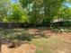 Fenced backyard featuring a well-manicured lawn and wooded views at 441 Highlands Loop, Woodstock, GA 30188