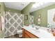 Bathroom with a shower-tub combination, green walls, and a large mirror at 441 Highlands Loop, Woodstock, GA 30188
