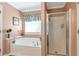Bathroom featuring soaking tub, tiled shower, and neutral colored walls at 441 Highlands Loop, Woodstock, GA 30188