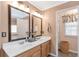 Bathroom with double sink vanity, framed mirrors, and light colored walls at 441 Highlands Loop, Woodstock, GA 30188