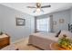 Cozy bedroom with a ceiling fan, neutral decor, and a comfortable bed at 441 Highlands Loop, Woodstock, GA 30188