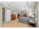 A spacious bedroom with tray ceilings and a ceiling fan, featuring neutral walls and carpeting at 441 Highlands Loop, Woodstock, GA 30188