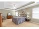 Spacious bedroom with tray ceilings, neutral carpeting, and traditional style furnishings at 441 Highlands Loop, Woodstock, GA 30188