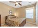 Bedroom featuring a ceiling fan, comfortable bed, and window with blinds at 441 Highlands Loop, Woodstock, GA 30188