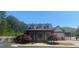 Elegant clubhouse featuring a welcoming entrance, manicured landscaping and peaked roof at 441 Highlands Loop, Woodstock, GA 30188