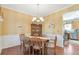 Formal dining room with hardwood floors, wainscoting, and traditional chandelier at 441 Highlands Loop, Woodstock, GA 30188