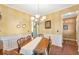 Bright dining room featuring wainscoting, chandelier and hardwood floors at 441 Highlands Loop, Woodstock, GA 30188