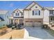 Charming two-story home with a well-maintained lawn, a two-car garage, and a welcoming front porch at 441 Highlands Loop, Woodstock, GA 30188
