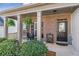 Inviting front porch with brick siding, decorative plants, and a cozy seating area creating curb appeal at 441 Highlands Loop, Woodstock, GA 30188