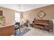 Spacious home office with a desk, chair, piano, and ample natural light at 441 Highlands Loop, Woodstock, GA 30188