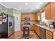 Kitchen with stainless steel refrigerator, wood cabinets, granite countertops, and a functional center island at 441 Highlands Loop, Woodstock, GA 30188