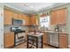 Traditional kitchen featuring stainless steel appliances, granite countertops, and ample cabinet space at 441 Highlands Loop, Woodstock, GA 30188
