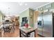 Open-concept kitchen featuring stainless steel fridge and center island; adjacent to breakfast area at 441 Highlands Loop, Woodstock, GA 30188