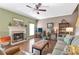 Comfortable living room with a fireplace, hardwood floors, and a cozy seating arrangement at 441 Highlands Loop, Woodstock, GA 30188