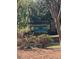 The Highlands Mountain Brook neighborhood sign surrounded by lush greenery and colorful flowers at 441 Highlands Loop, Woodstock, GA 30188