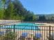 Large outdoor swimming pool area with lounge chairs, surrounded by lush trees at 441 Highlands Loop, Woodstock, GA 30188