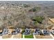 Expansive aerial view showing a neighborhood with wooded areas and a community landscape at 7560 Wild Violet Dr, Cumming, GA 30040