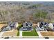 Wide aerial shot of a home nestled within a community, highlighting the lush surroundings and neighborhood layout at 7560 Wild Violet Dr, Cumming, GA 30040