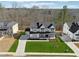 Stunning aerial view of a modern home showcasing its manicured lawn and upscale community at 7560 Wild Violet Dr, Cumming, GA 30040