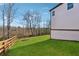 Picture of a well-manicured backyard lawn, complemented by a wooden fence and backing onto a wooded area at 7560 Wild Violet Dr, Cumming, GA 30040