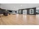 Expansive finished basement with sleek bar, contemporary furnishings, and access to the outdoors through French doors at 7560 Wild Violet Dr, Cumming, GA 30040