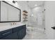 Bathroom featuring walk-in shower, marble accents, and modern vanity at 7560 Wild Violet Dr, Cumming, GA 30040